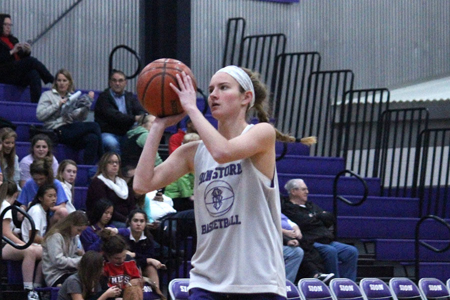 Senior Maddie Young prepares to shoot the basketball in warmups before the scrimmage Nov. 10.