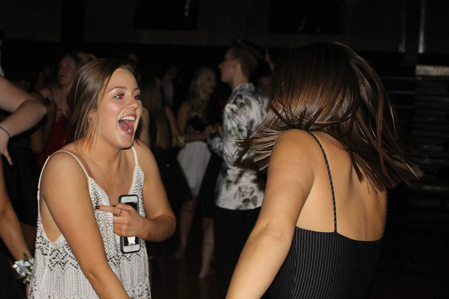 Seniors Megan Breckenridge and Lauren Ismert dance together on the dance floor.