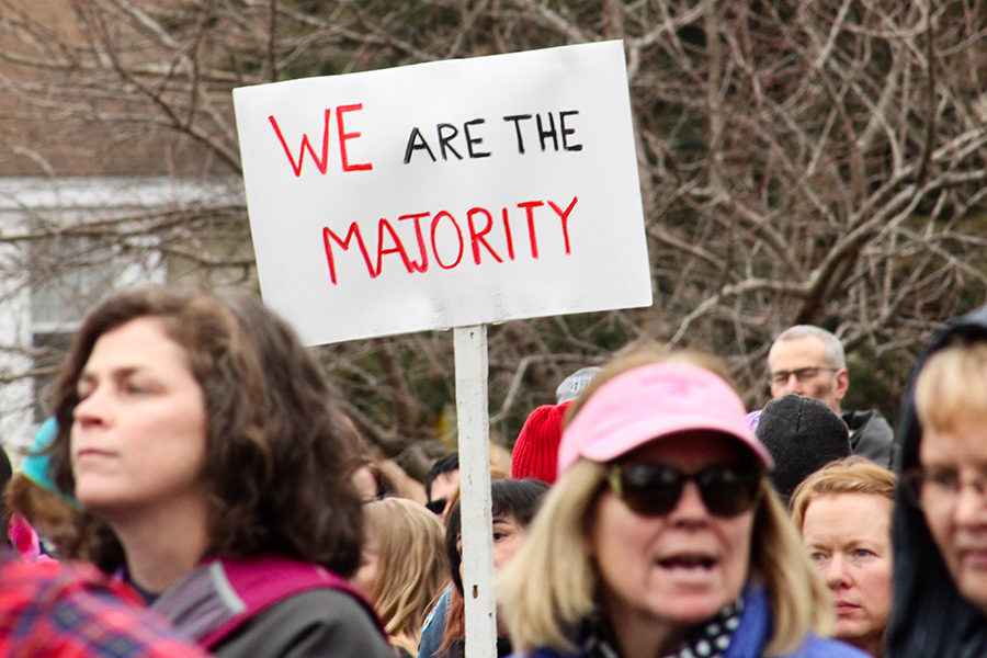 A sign is held up above the crowd at the Women’s March in Lawrence, Kansas Jan. 20.