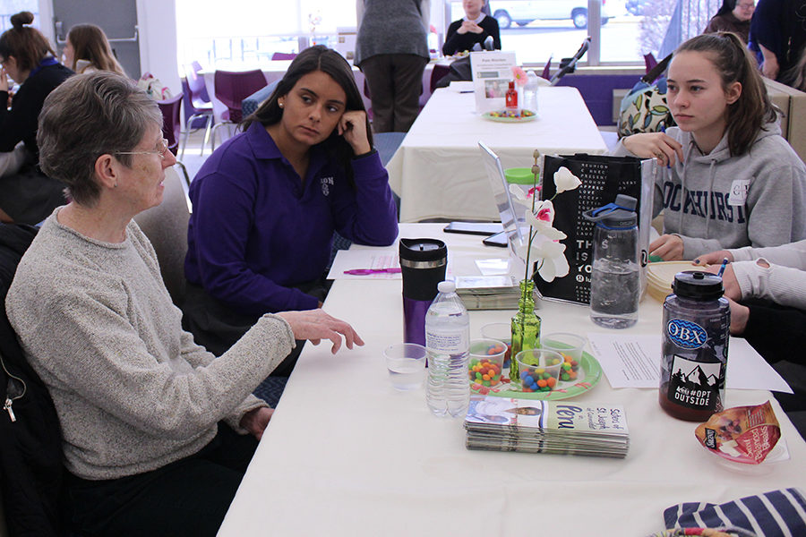 Seniors Sophie Mount and Melissa Hamilton listen intently during lunch as Sister Rose McLarney talks to them about her day to day life.