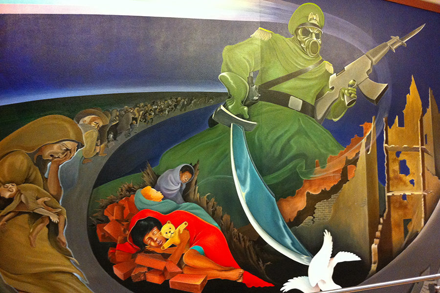 This mural painted in the Denver International Airport, named “Sinister Sites,” depicts a man with a Nazi hat and gas mask for a face holding a sword in one hand and a rifle in the other with an endless number of suffering people behind him.