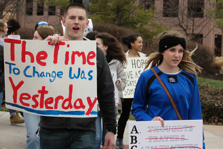 Marching down Emanuel Cleaver II Blvd, a man holds a sign in front of his body at the March For Our Lives in Kansas, City Missouri March 24.