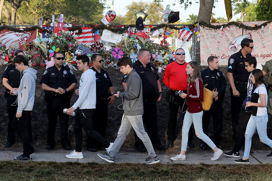 Students head back to school at Marjory Stoneman Douglas High School on Wednesday, Feb. 28 for the first time after a gunman killed 17 students in the school Feb. 14.