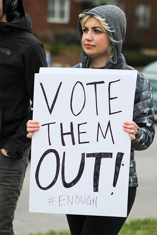 While marching with fellow protestors, a woman holds up a sign given to her at the march at the March For Our Lives held at Theis Park in Kansas City, Missouri March 24.