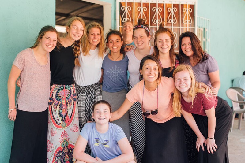 Taking a break from teaching English classes March 16, senior Lanie Jones poses with the other high school girls and two chaperones on the trip. This was the group’s last day of teaching.