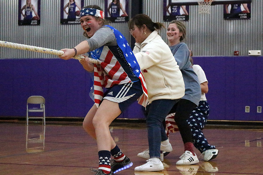 Seniors Bailey Runchey, Suh Yun Park and Annie Murphy compete in Tug-O-War against the juniors March 2. The America-themed class fell in the first round of Tug-O-War, but won 1st place in the overall games.