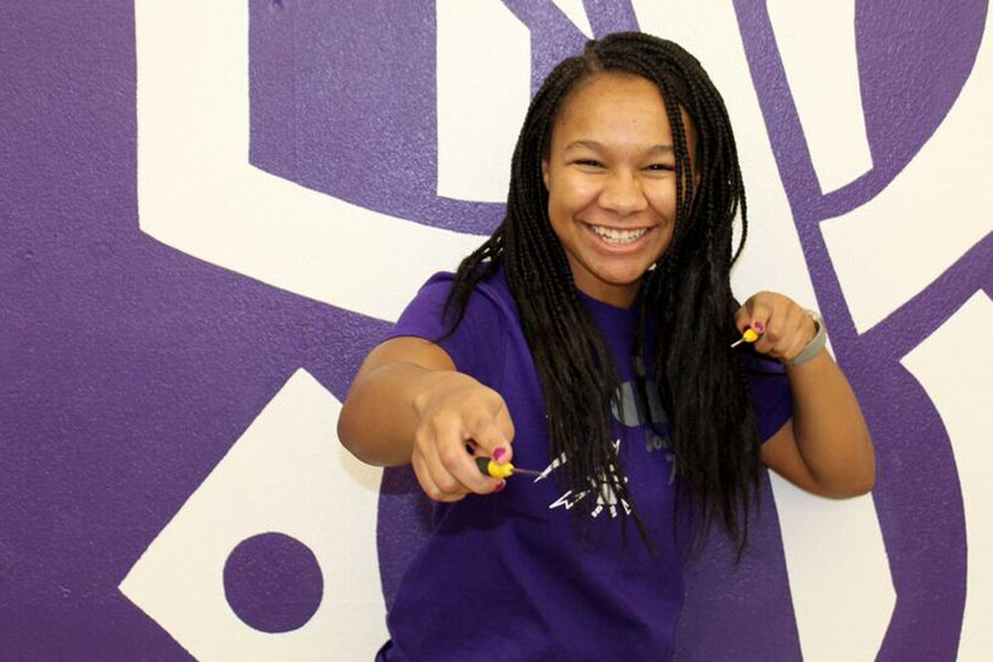 Junior Sade-Joy Dugbo poses with two screwdrivers she uses to build and fix the robot used for the high school’s robotics competitions.