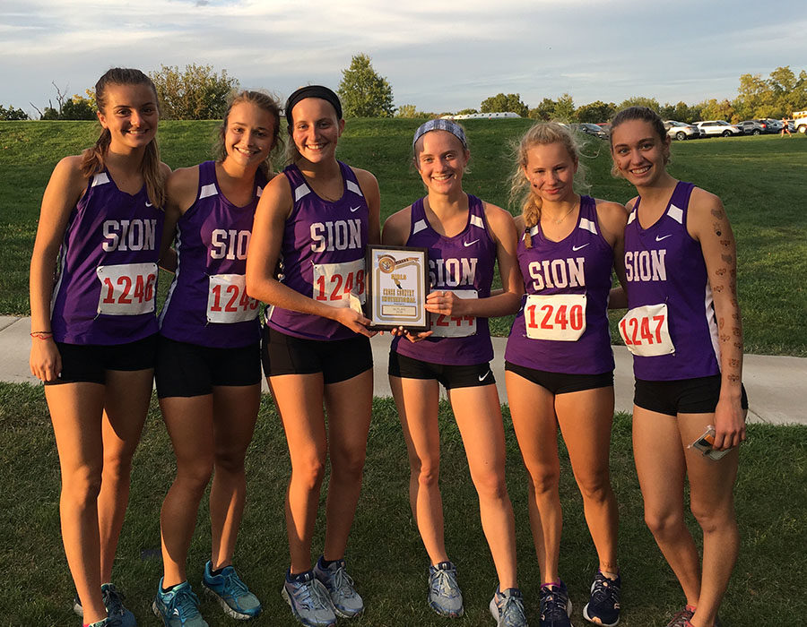 Juniors Rose Orrick and Nina Trouve, senior Gretta Allen, junior Lily Henkle, sophomore Dillan Elmquist and senior Brenna Richart proudly show off their first place plaque after winning the Excelsior Springs Invitational on Oct. 2.