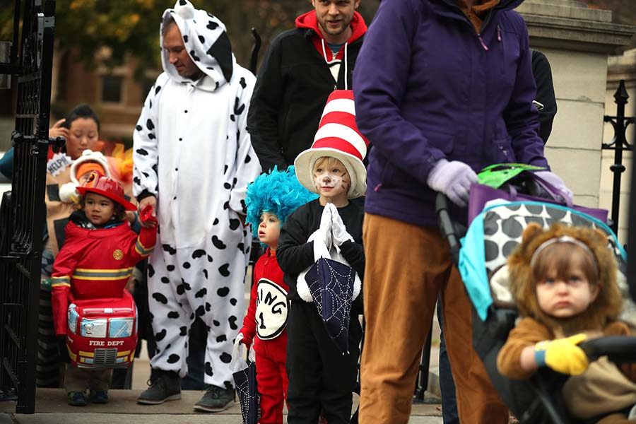 Children and their families wait in line to greet Minnesota Gov. Mark Dayton during Halloween festivities at the Governor's Mansion in St. Paul, Minn., on Tuesday, Oct. 31, 2017. Full-sized candy, apple cider and glow sticks were handed out. (Leila Navidi/Minneapolis Star Tribune/TNS)