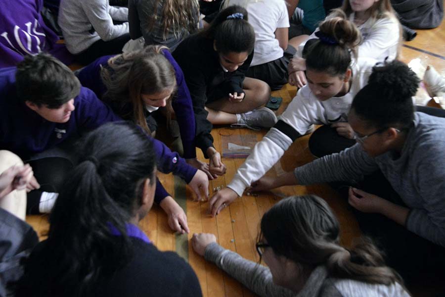 Students gather in groups of 10 to create bracelets made of five beads, to symbolize the four different presented faiths and the prayer of music at the interfaith prayer service Nov. 15.  Prayer beads serve as a common shared tradition across a variety of religions.