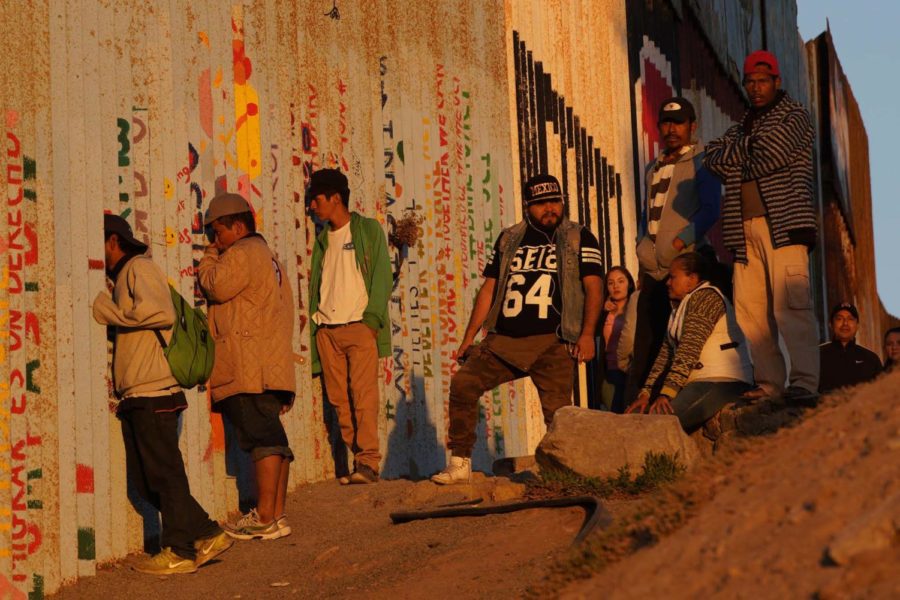 During sunset, a few from the group peered through the bollard fence watching the action of U.S. Border patrol agents on the north side of the fence on Nov. 14, 2018. (Nelvin C. Cepeda/San Diego Union-Tribune/TNS)