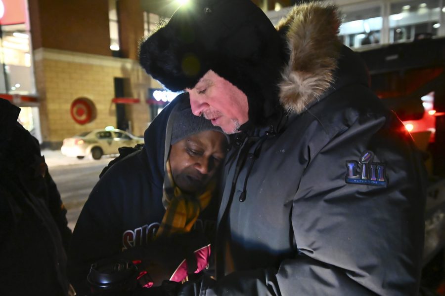 Pastor John Steger, with Grace In The City church, embraces Jearline Cyrus, a homeless woman, in downtown Minneapolis on Tuesday night, Jan. 29, 2019 while delivering cold-weather gear, hot chocolate and food with Minneapolis Police Sgt. Grant Snyder. (Aaron Lavinsky/Minneapolis Star Tribune/TNS)