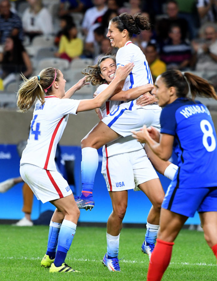 USA's Carli Lloyd jumps into the arms of teamate Heath Tobin after scoring a goal against France in the second half during Summer Olympics action in Belo Horizonte, Brazil, on Saturday, Aug. 6, 2016. The U.S. won, 1-0. (Wally Skalij/Los Angeles Times/TNS)