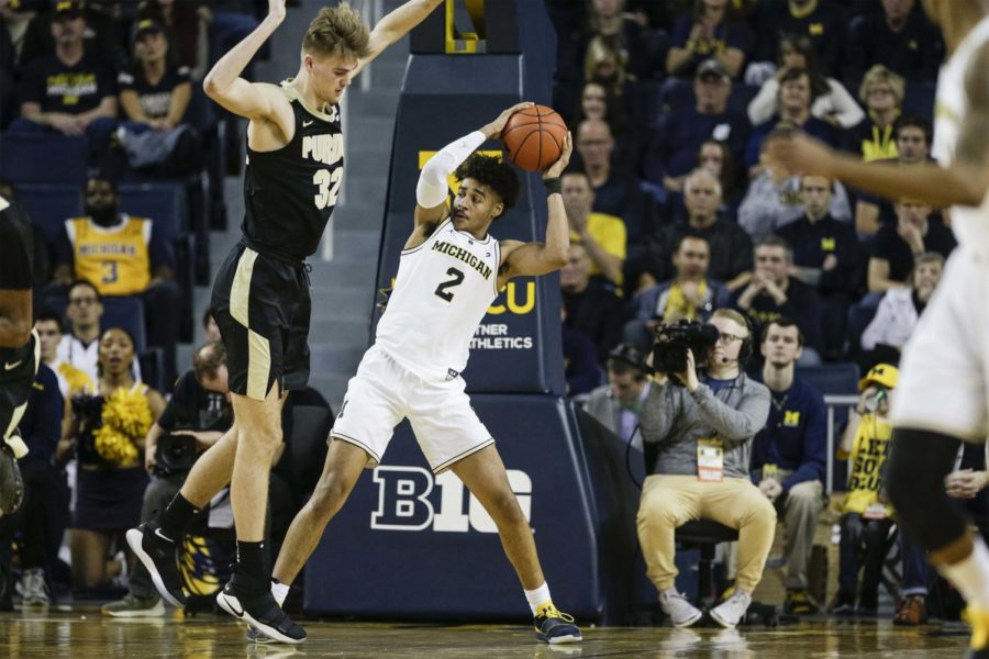 Michigan guard Jordan Poole (2) tries to pass the ball after getting a defensive rebound against Purdue center Matt Haarms (32) at Crisler Center in Ann Arbor, Mich., on December 1, 2018. (Junfu Han/Detroit Free Press/TNS)