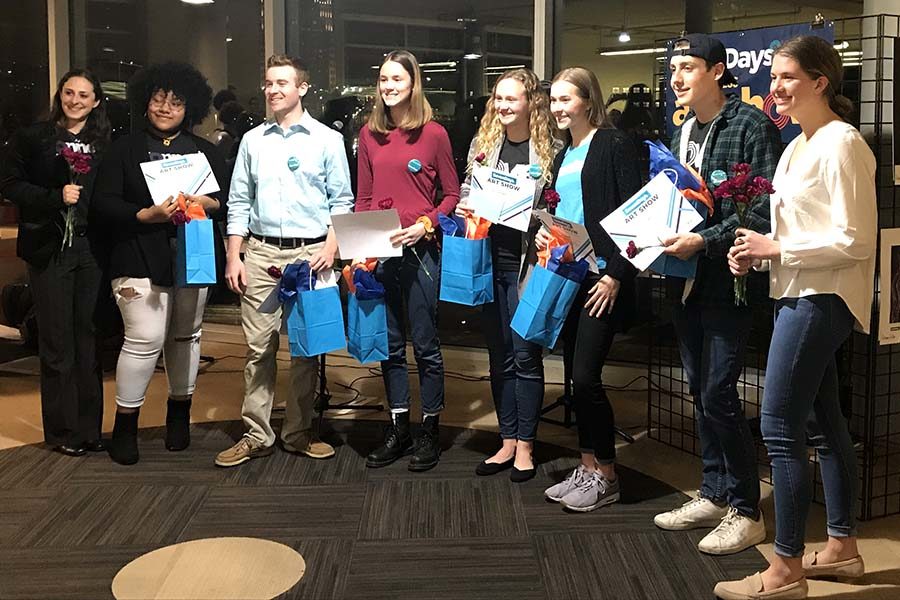 Sophomore Olivia Overlease attended the art showcase for the winning students of the Seven Days Art Contest at the Plaza Library Feb. 26. Overlease is the fourth person from the right.