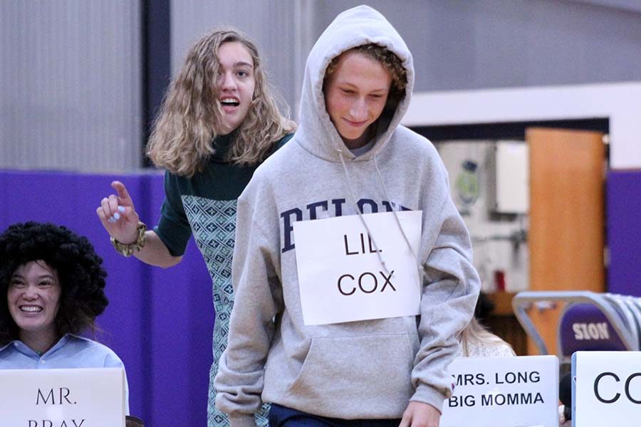 Walking up to the center of the gym in the senior Food for Thought skit senior Brenna Richart bring English teacher Mrs. Cox’s son Oct. 26.