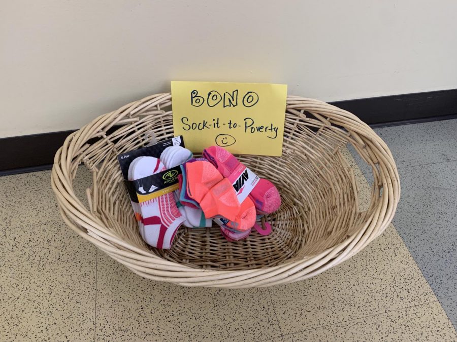 As Sock it to Poverty kicks off, french teacher Liz Bono was among the first to set out collection bins.