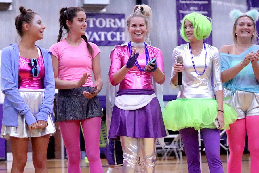 Tennis seniors Emily Rine, Caroline Boessen, Logan Dixon, Holly Frey and Avery Kuhls cheer on their fellow tennis players in the crowd at the pep assembly Sep. 10. 