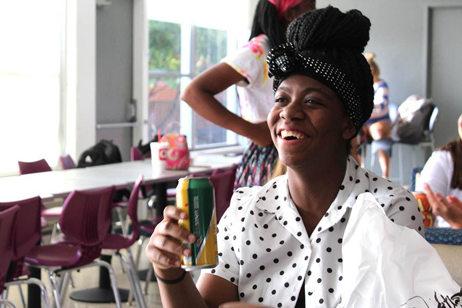 Decked out in polka dots, junior Shakyra Wilburn chats with friends before school in the cafeteria Sept. 9. For the start of Spirit Week, students participated in Pattern Day.