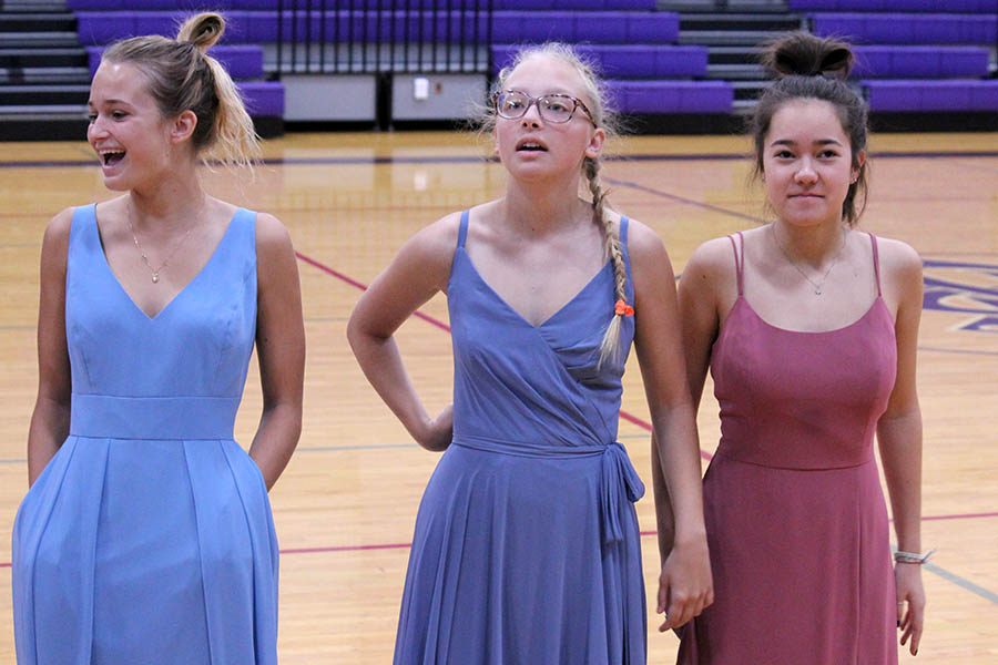 Seniors Nina Trouve, Brie Bowes and Paula Sweeny showed three of the five dress options to the senior class Oct. 16 during the class meeting. Graduation dresses are ordered from Bella Bridesmaids.