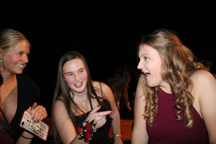 Juniors Sharon Kramschuster, Mason Lewis and Haley Langle share a laugh at Winter Formal on Dec 7. 