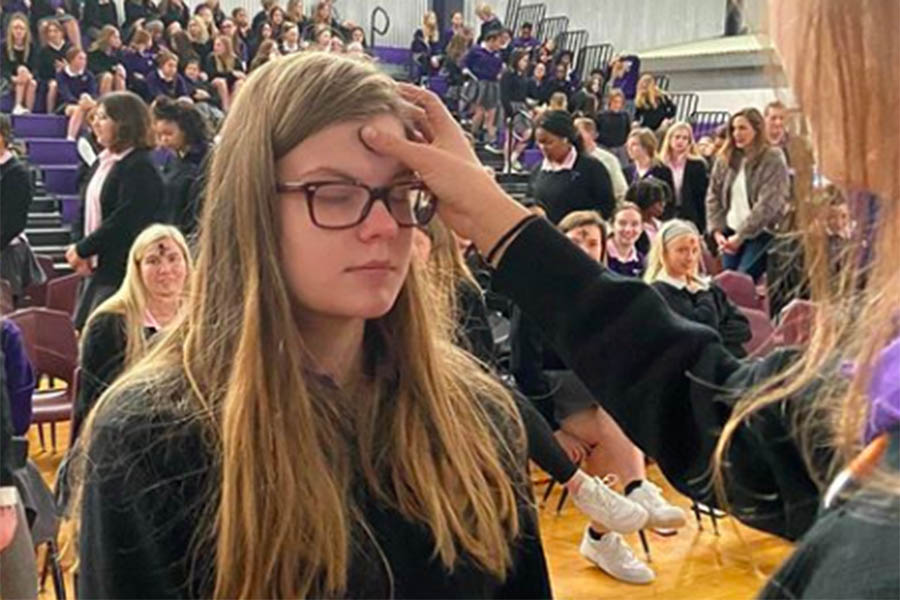 Senior Kirstina Kreidler recieves ashes during the Ash Wednesday Mass Feb. 26. Recognizing the start of Lent, students, faculty and guests gathered in the gym for Mass precided by Father Jerry Waris. 