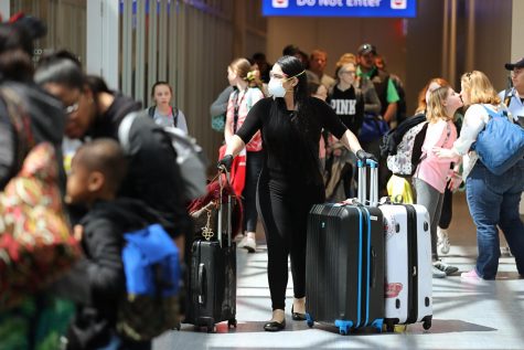 Some arriving travelers at the Orlando International Airport wear masks Thursday, March 12. 