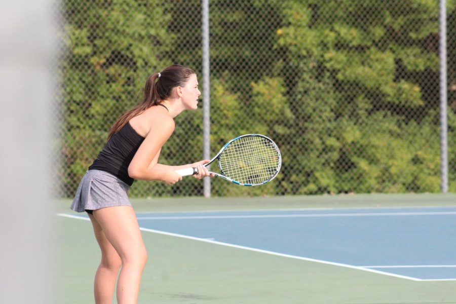 Senior Lindsey Dougherty waits in anticipation to receive a serve from Lexi Gunn during a tennis match against Blue Valley high school on Sept. 22