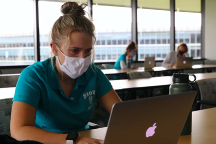 Senior Hannah McGraw works on her project for the Designing Real World Impacts Class at the Burns & McDonnell headquarters on Aug. 31.