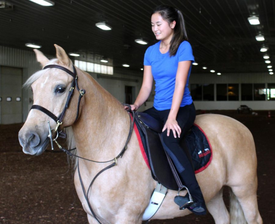 Sophomore Lauren Stuckmeyer rides her horse around the arena on Sept. 23. Stuckmeyer has been an avid horse fan since she was two years old.