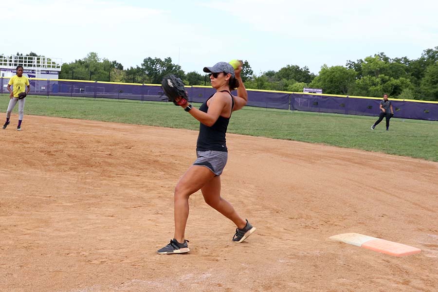 Softball coach Madi Osias demonstrated proper throwing technique to the softball team during practice on Sept. 8. Osias played professional softball as a pitcher with the Pennsylvania Rebellion.