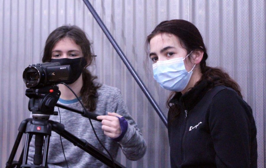 Freshman Tessa Thompson and Sophomore Megan Kelley prepare to film Sion's basketball senior night. (Sofia Aguayo)