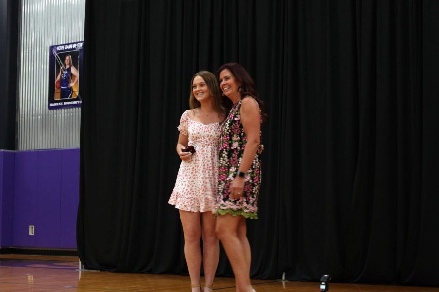 Senior Audrey O'Brien and family friend Melissa DeLeon pose in front of the photographer after DeLeon presented O'Brien with her ring.  