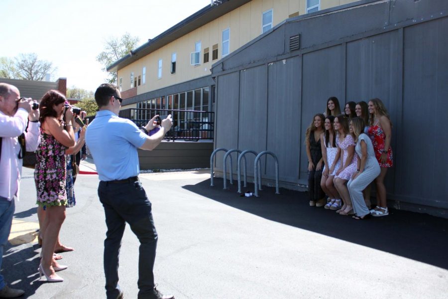 Seniors Brynna Dow, Keely Schieffer, Kate Conway, Mikayla Gunther, Ruby Wright, Lindsey Dougherty, Audrey O'Brien, and Julia Hughes pose while parents take pictures at the reception that took place after the ceremony. 