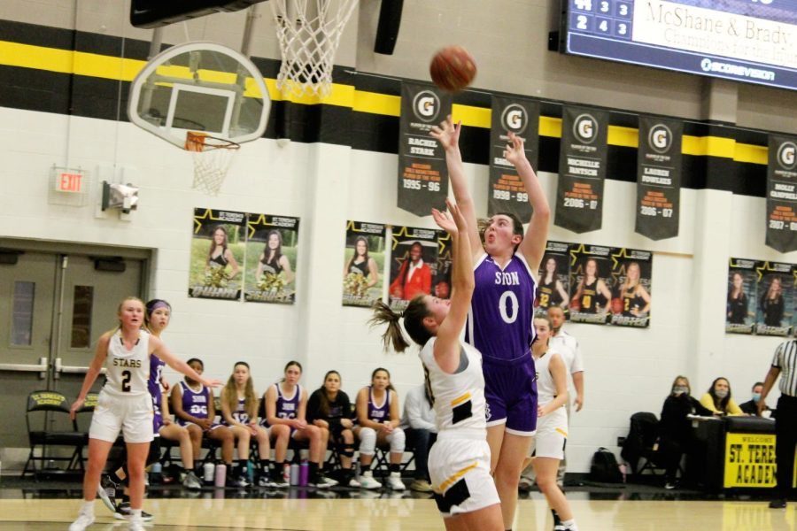 Freshman Grace Renners collides with a St. Teresa's player as she goes in for a layup.