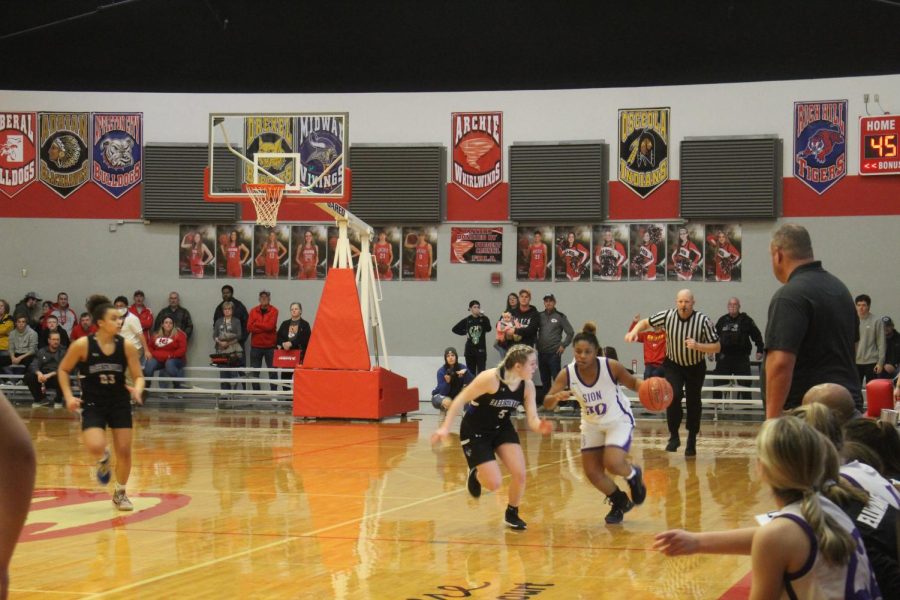 Freshman Terryn Ford dribbles the ball, and withholds it from the other team. 