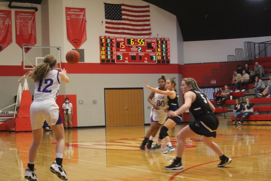 Junior Makayla Herbert stretches her arms to reach the ball. 