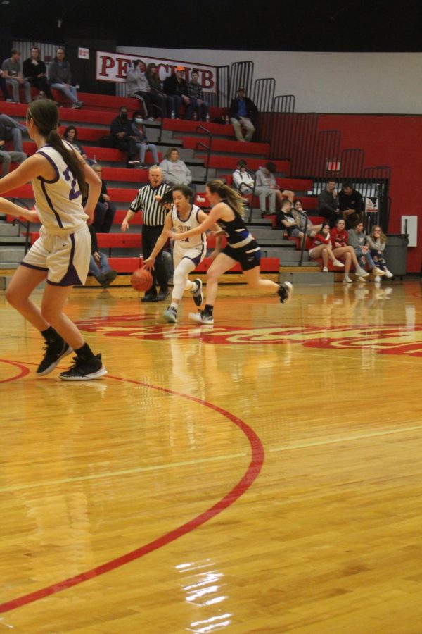 Senior Anna Sheedy watches the two teams wrestle for the ball. 