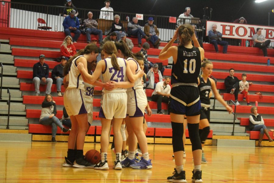 Some of the team members talk to one another during the game. 