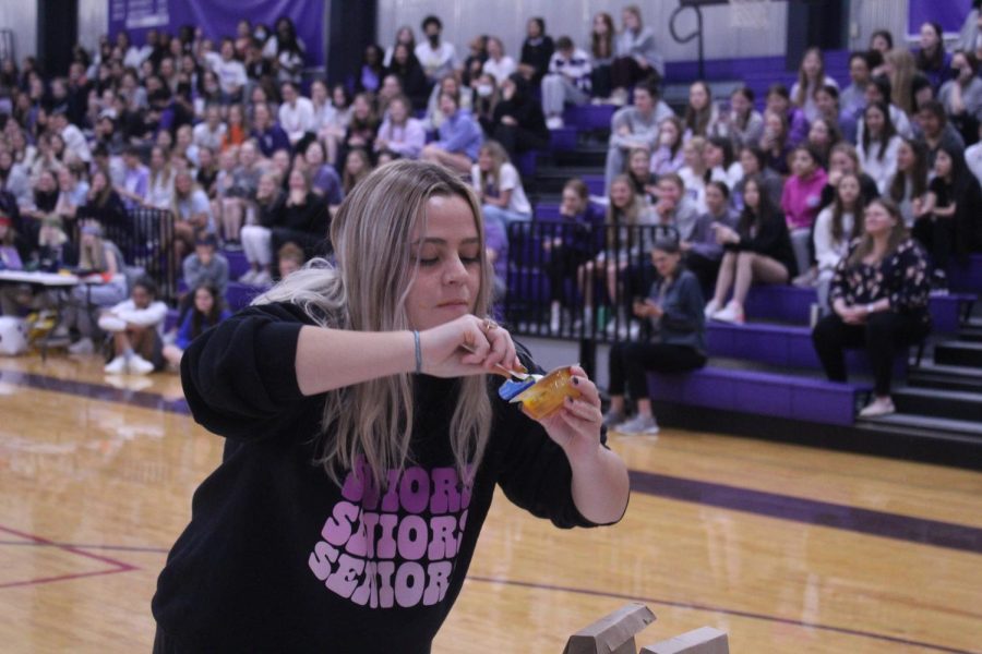 Senior Maddie Haukap tries to eat baby food as quickly as she can. 