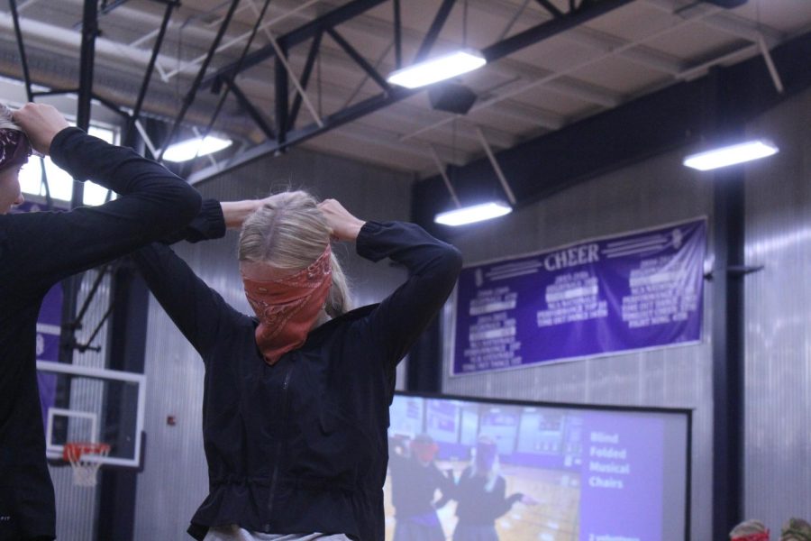 Senior Grace Townsend ties a bandana around her head. 