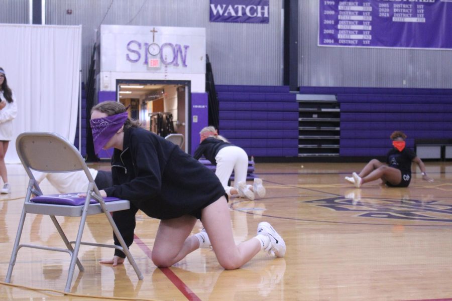 Sion student reaches for the chair in a game of blindfold musical chairs. 