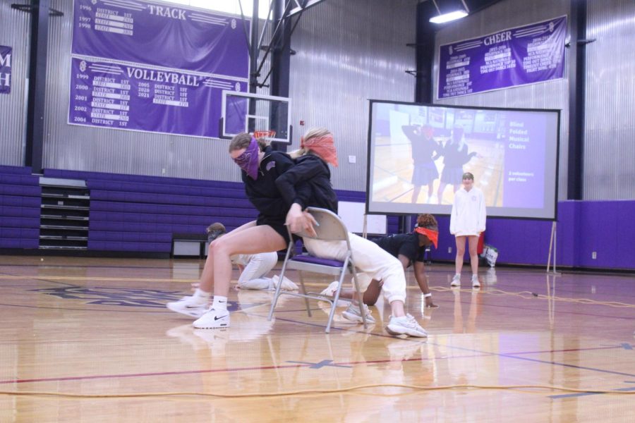 Senior Grace Townsend and another student fight over a spot in the chair. 