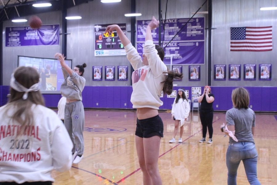 Senior Anna Sheedy shoots the basketball in an effort to make it in the basket. 