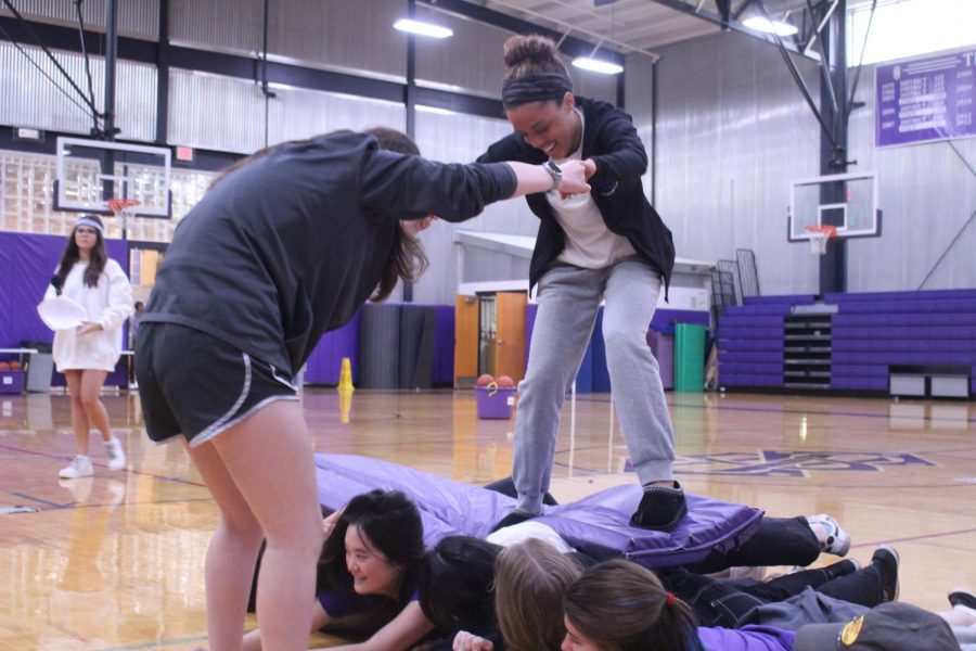 Junior Zoey Marshall surfs over her classmates.