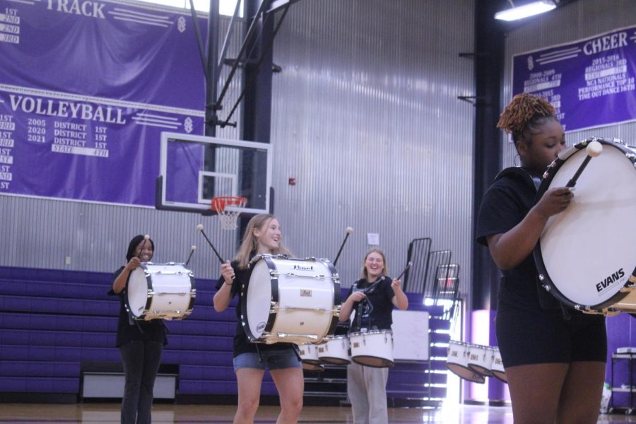 Members of the Drum Line laugh as they perform. 