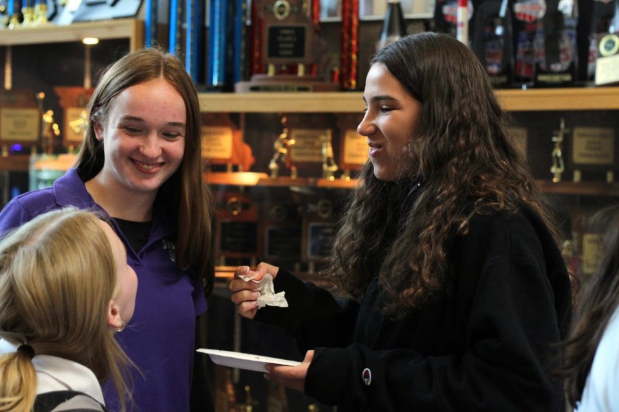 Freshman Taelyn Smith enjoys a treat as she chats with friends.