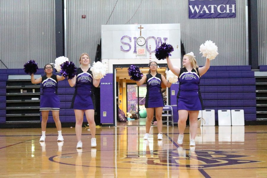 Juniors DeeDee Cohen and Tillie DeVolder cheer at the fall sports pep rally 