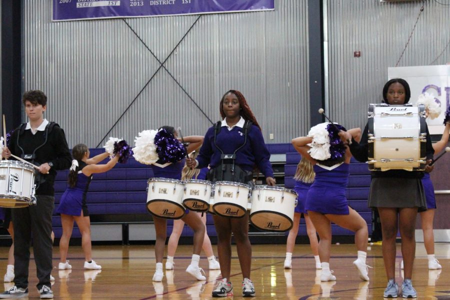 Senior Iyanna Coleman plays the drums during the drumline's performance 