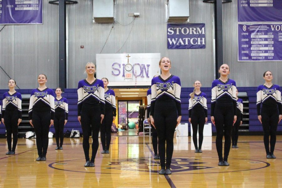 The Sion dance team gets ready to perform their kick routine at the fall sports pep rally 